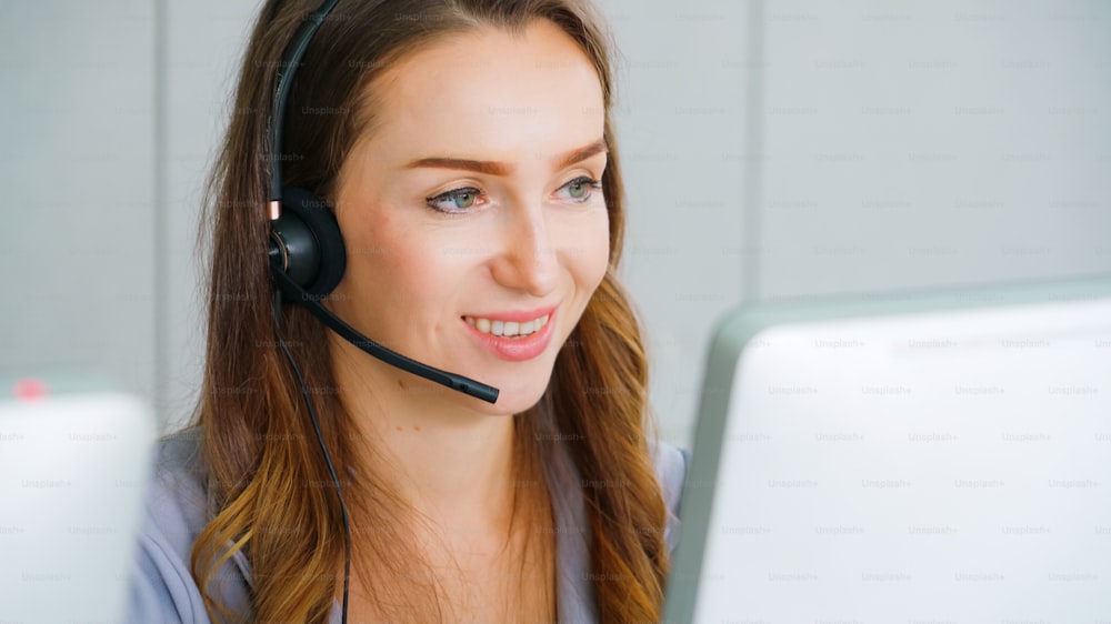 Business people wearing headset working in office to support remote customer or colleague. Call center, telemarketing, customer support agent provide service on telephone video conference call.