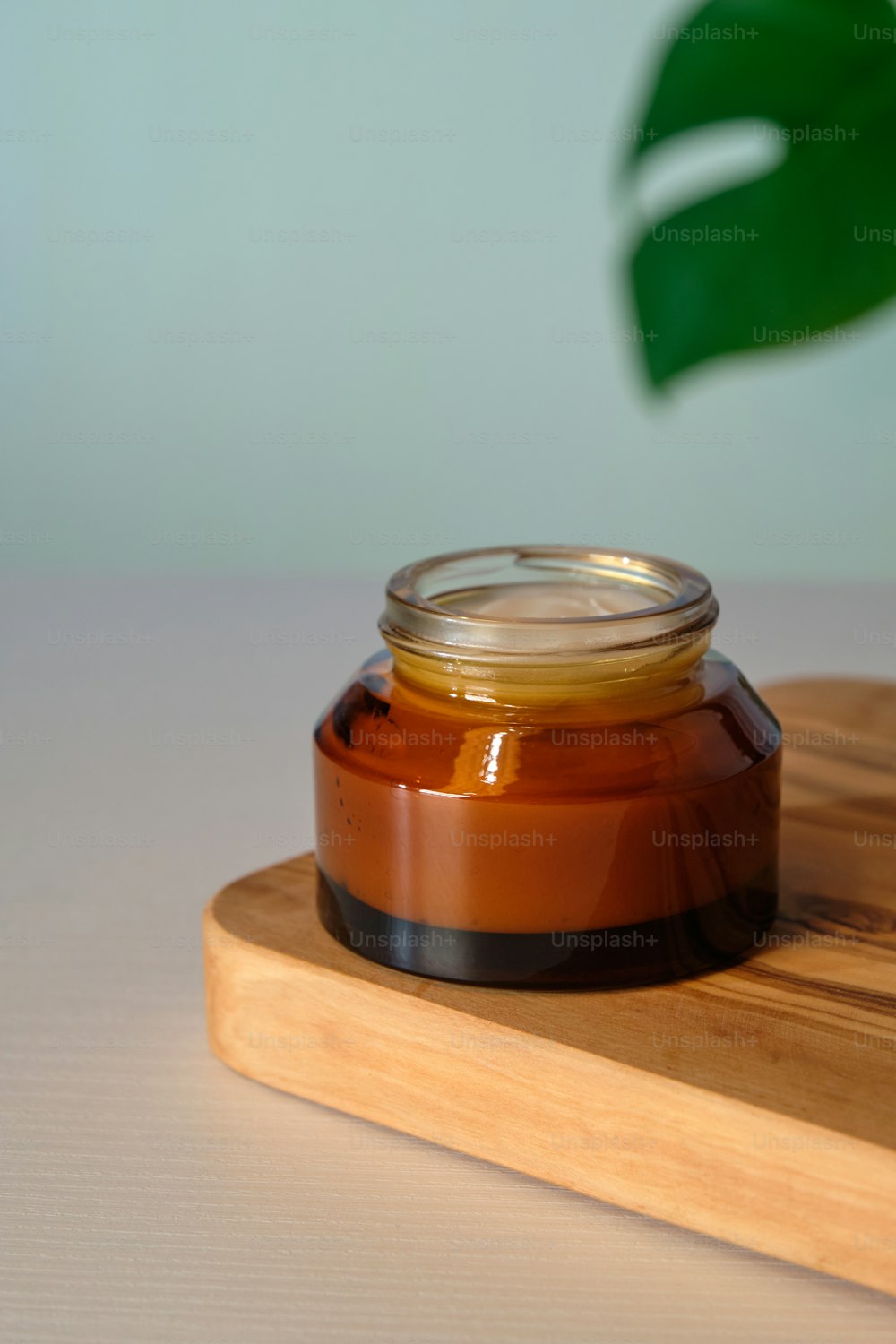 Amber glass jar of natural organic face cream. Moisturizer, skin care product concept.