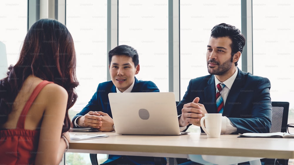 Job seeker in job interview meeting with manager and interviewer at corporate office. The young interviewee seeking for a professional career job opportunity . Human resources and recruitment concept.