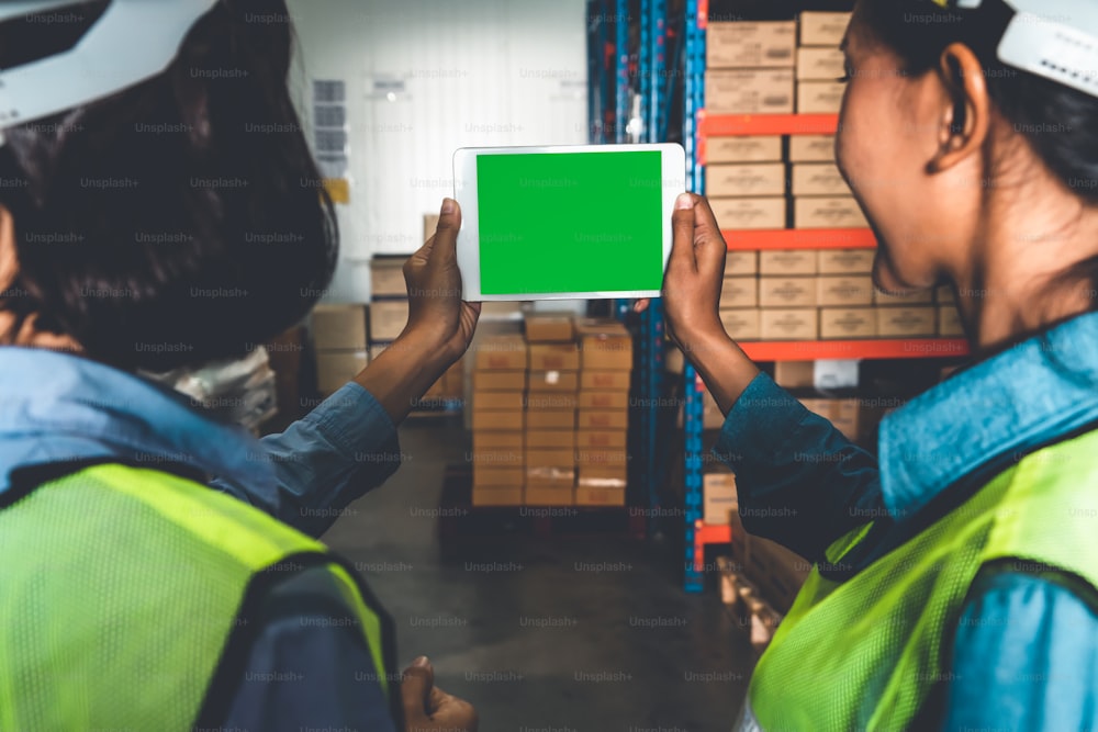 Computer with green screen display in warehouse storage room . Delivery and transportation software concept .