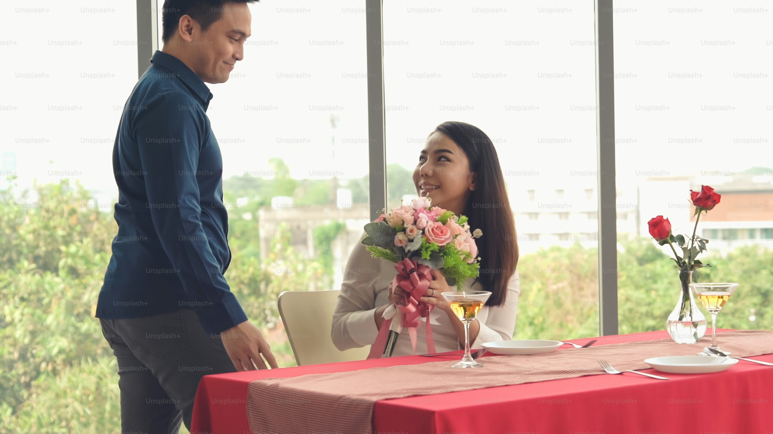 Romantic couple giving gift to lover at restaurant . Happy couple lifestyle .