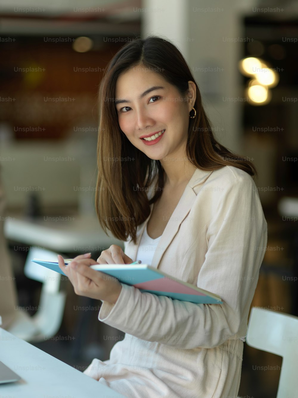 Portrait of businesswoman smiling to camera while planing schedule in office room