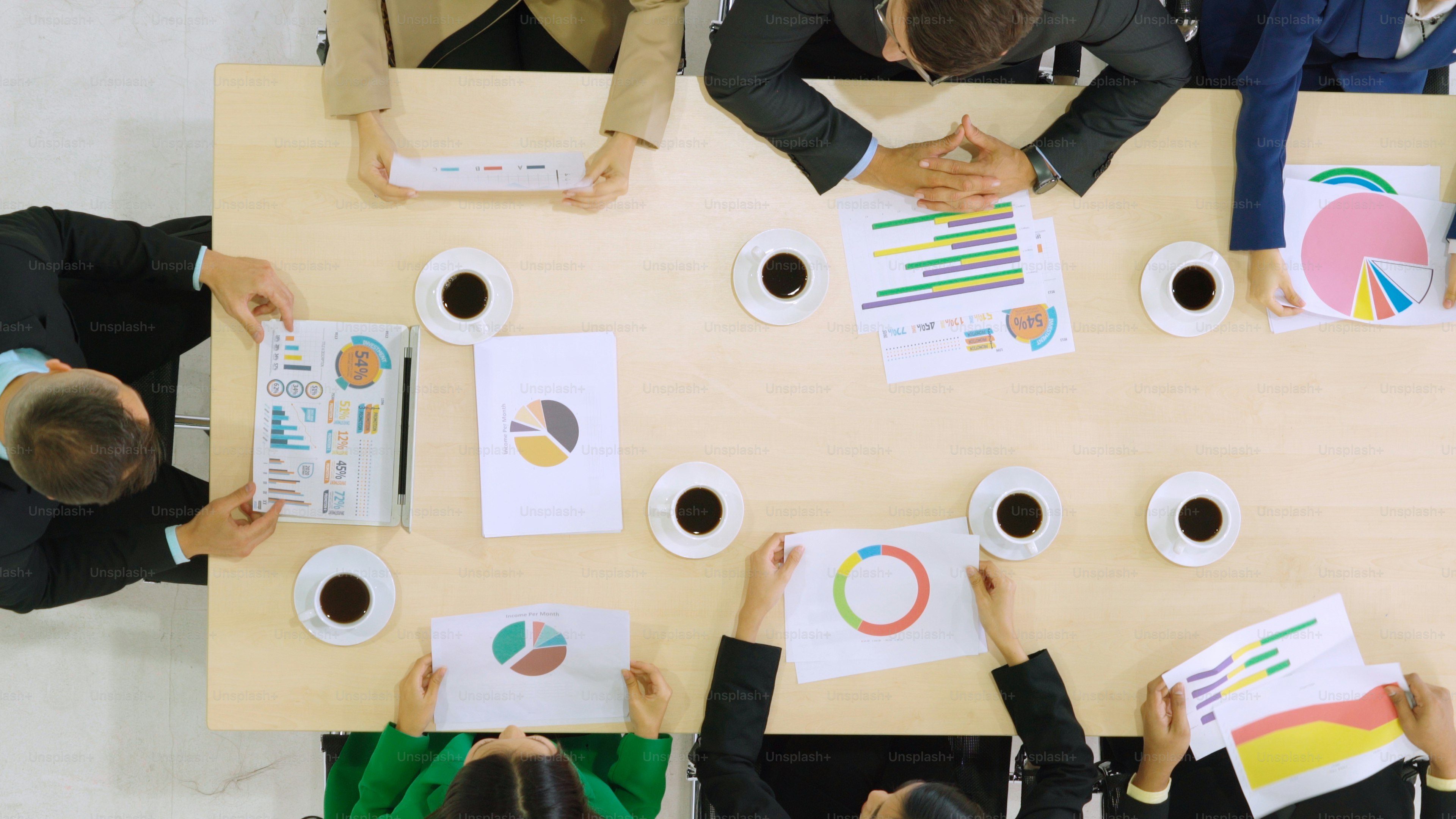 Business people group meeting shot from top view in office . Profession businesswomen, businessmen and office workers working in team conference with project planning document on meeting table .