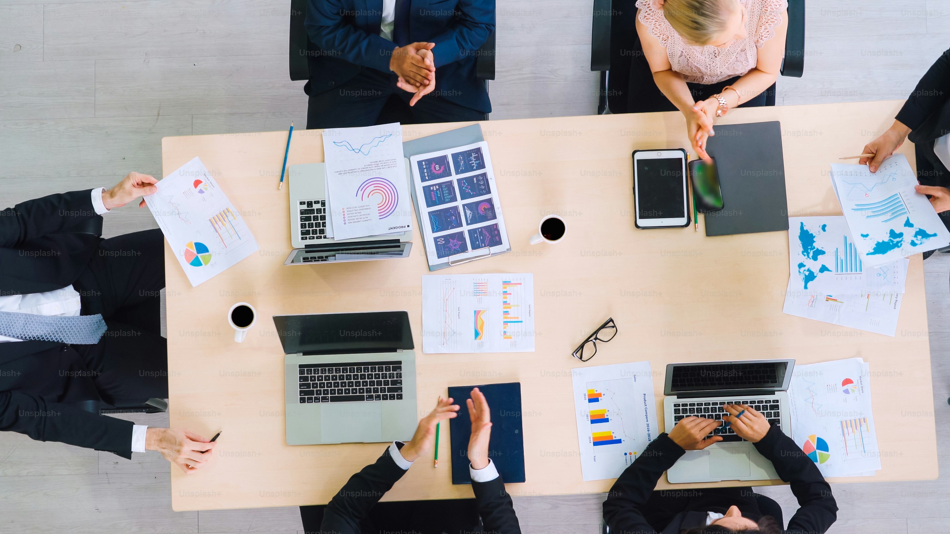 Business people group meeting shot from top view in office . Profession businesswomen, businessmen and office workers working in team conference with project planning document on meeting table .