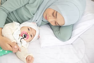 Baby And Mother At Home In Bed, Happy loving family