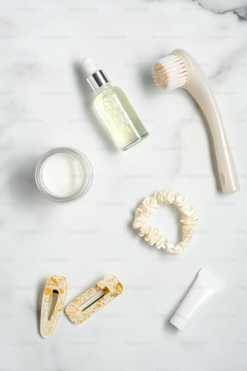 Set of body care cosmetics and feminine accessories on the marble table. Flat lay, top view.