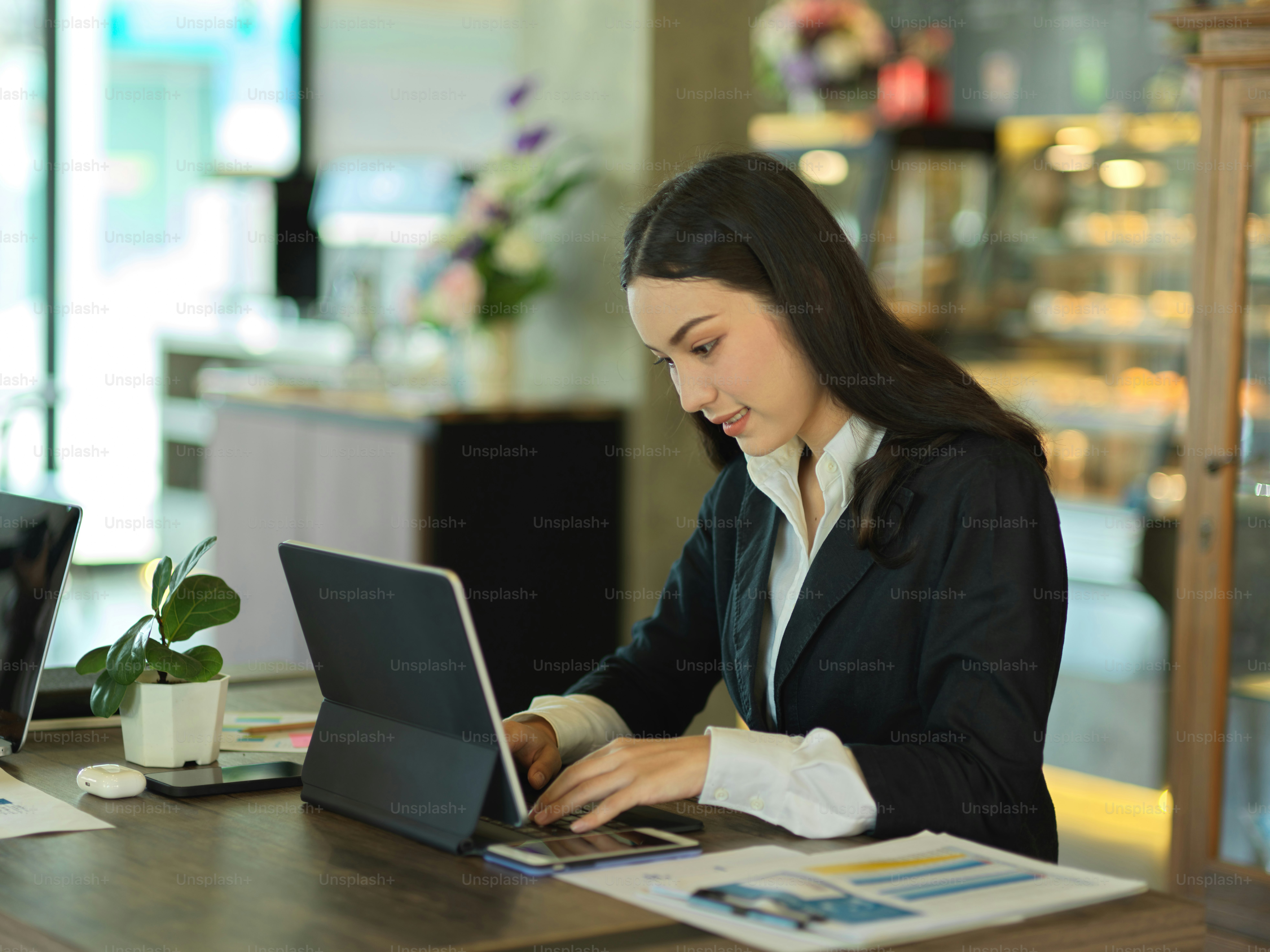 Portrait of young businesswoman working with digital tablet in modern office room