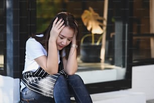 Young woman wearing waitress apron feeling suffering from desperate and stressed.