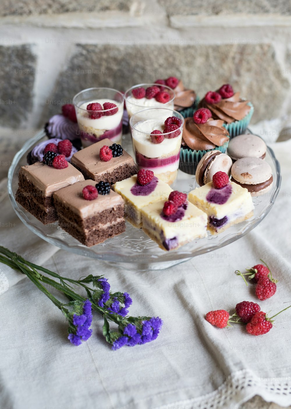 A top view of selection of colorful and delicious cake desserts on tray on table.