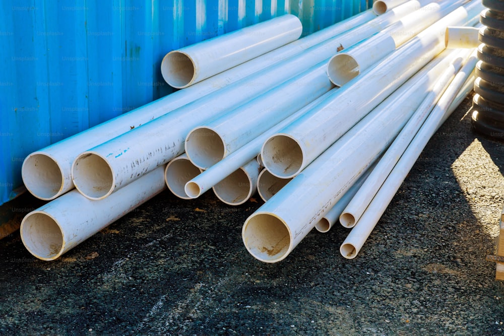 Pallets of white sewer PVC pipes at construction for drainage system