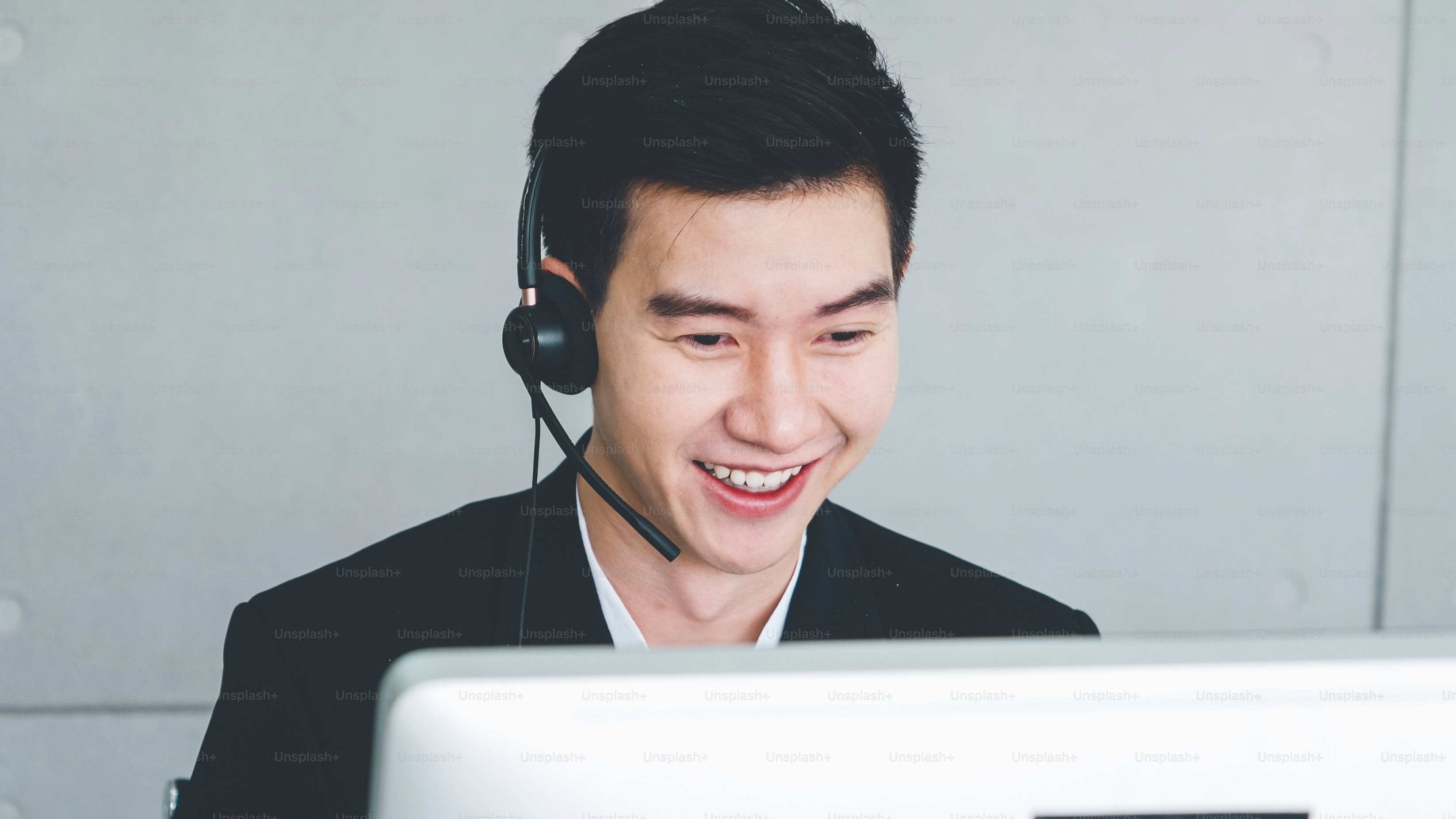 Business people wearing headset working in office to support remote customer or colleague. Call center, telemarketing, customer support agent provide service on telephone video conference call.