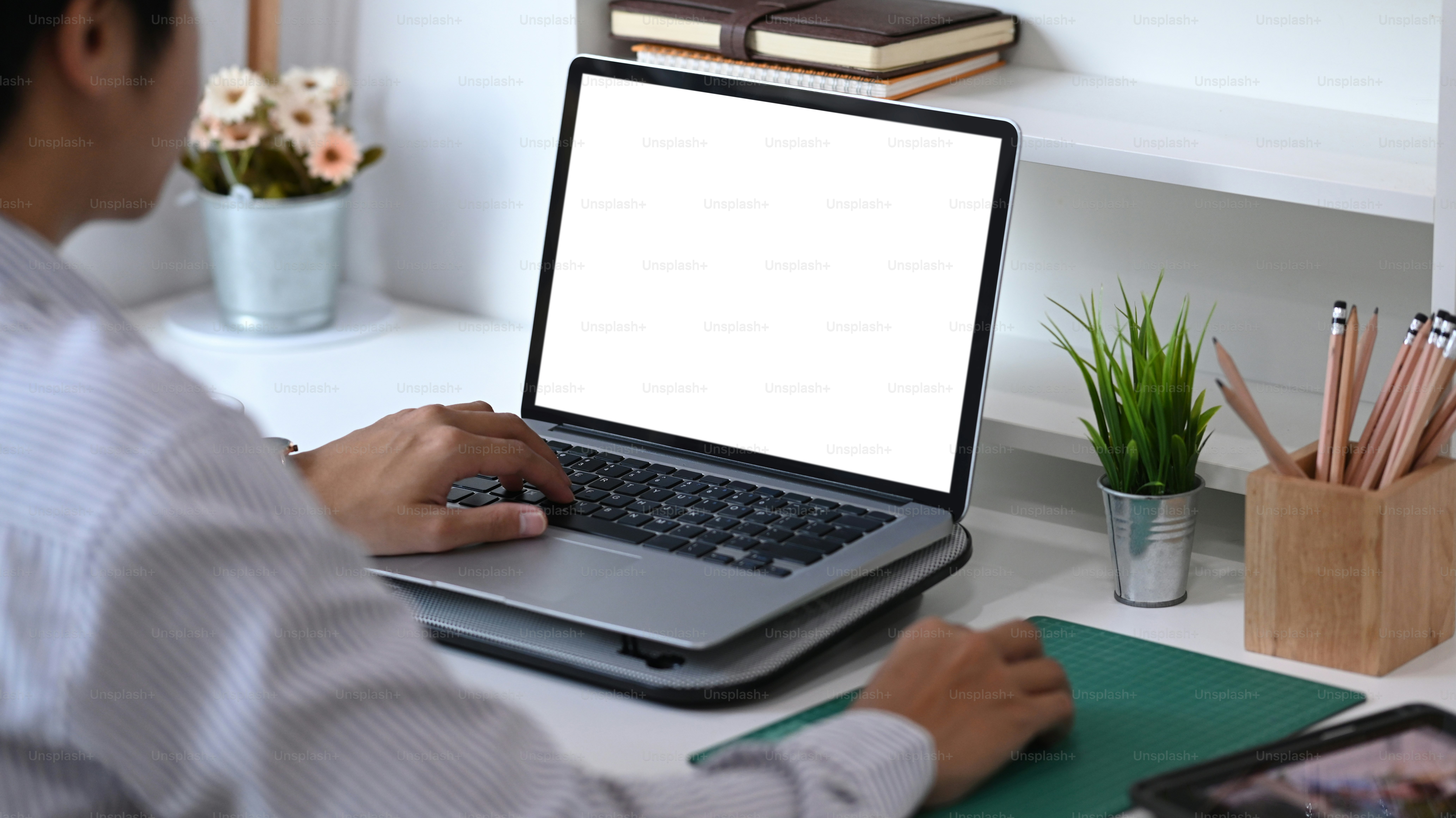 Young man using laptop contact business search information on desk in office. Blank screen for advertising text.