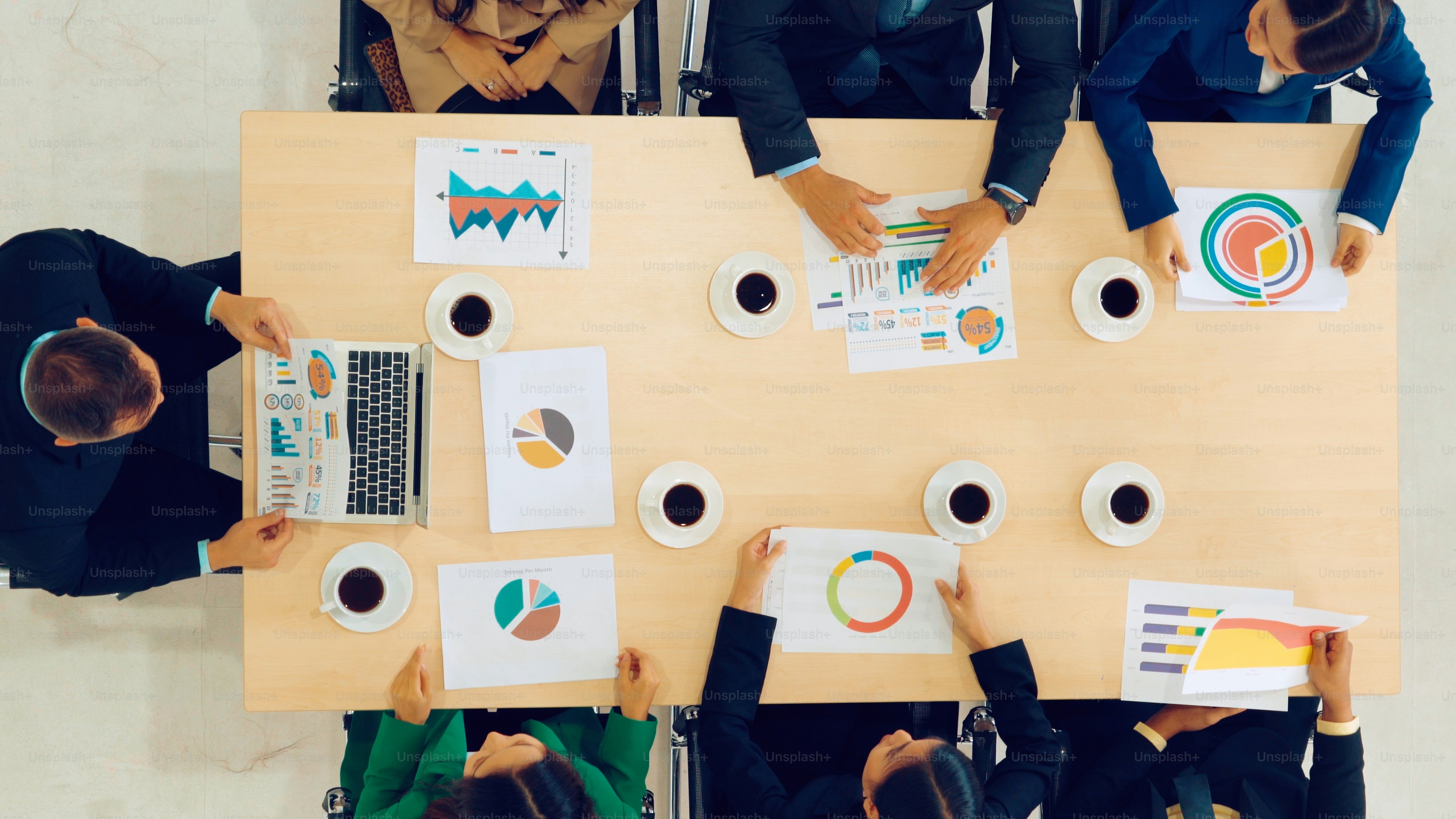 Business people group meeting shot from top view in office . Profession businesswomen, businessmen and office workers working in team conference with project planning document on meeting table .