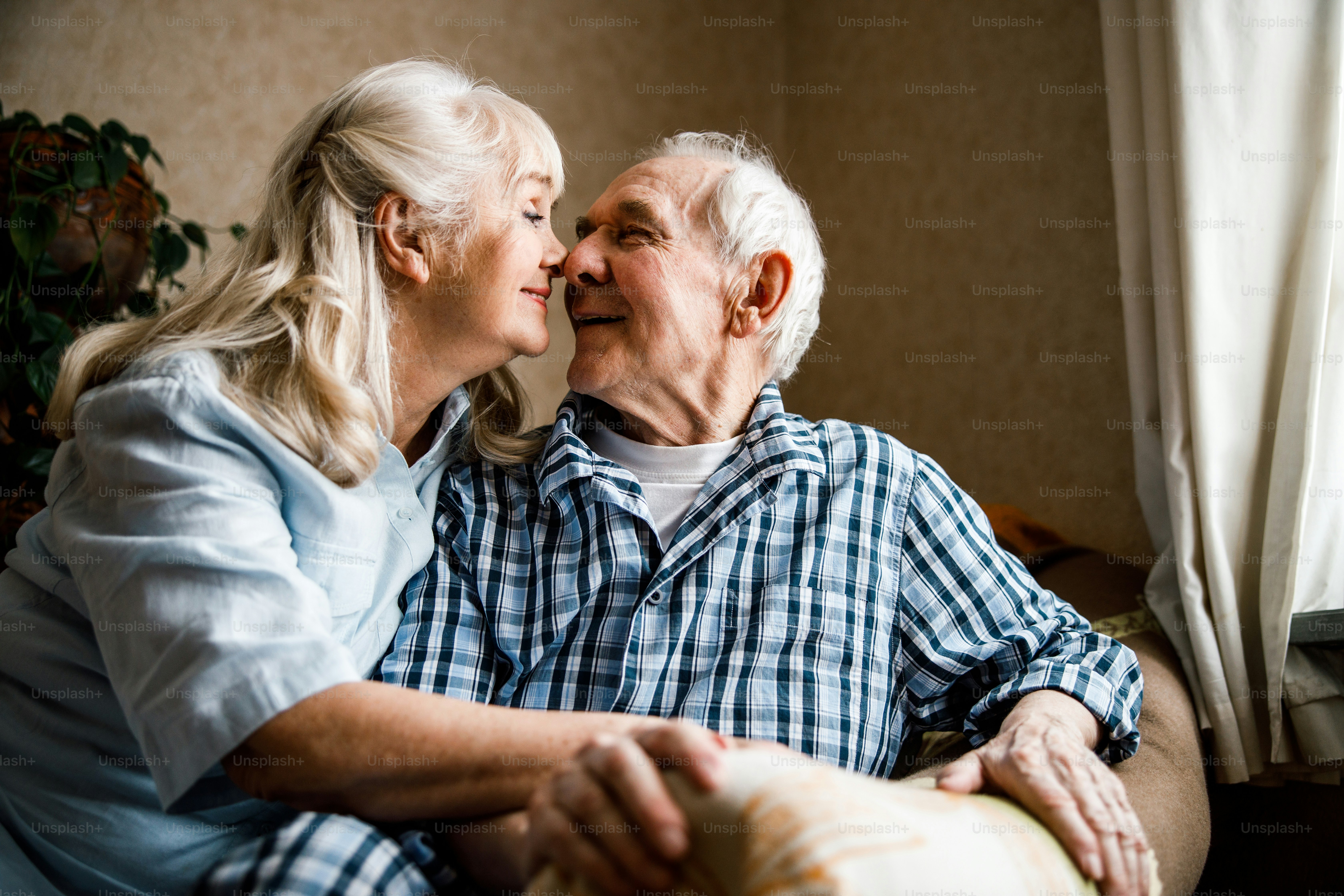 Wonderful mood. Happy delighted man smiling while sitting at the ...