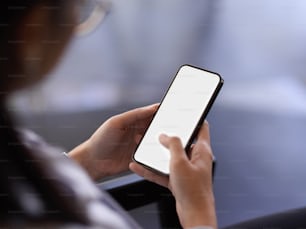 Close up view of female office worker relaxing with smartphone in office room