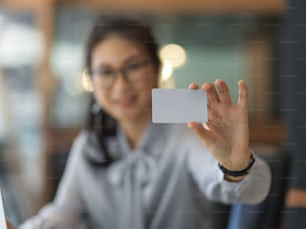 Close up view of female office worker showing mock up card name in blurred background