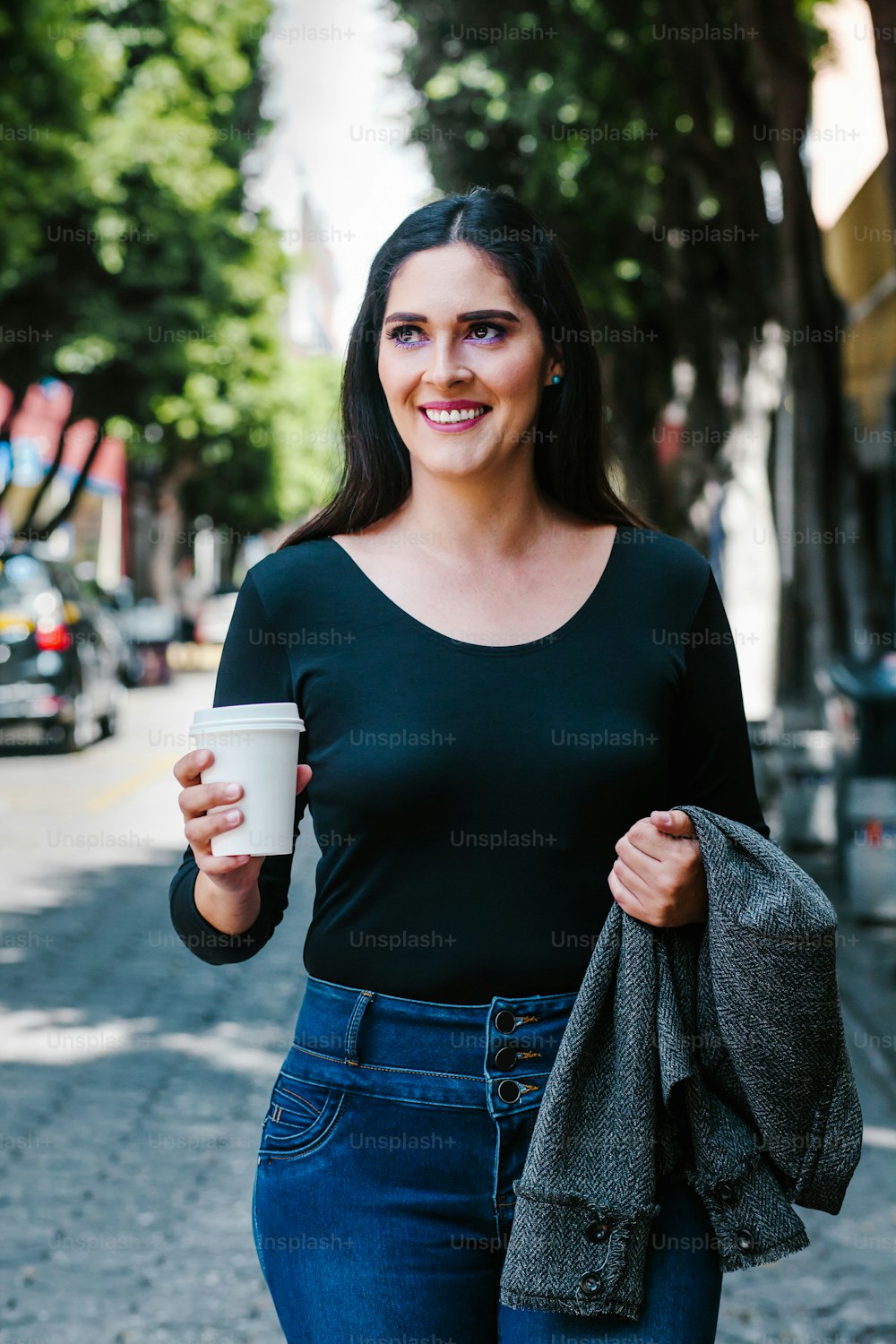 portrait of a latin woman walking in the streets of a colonial city in latin america