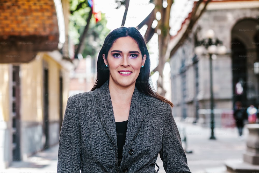 portrait of a latin woman walking in the streets of a colonial city in latin america