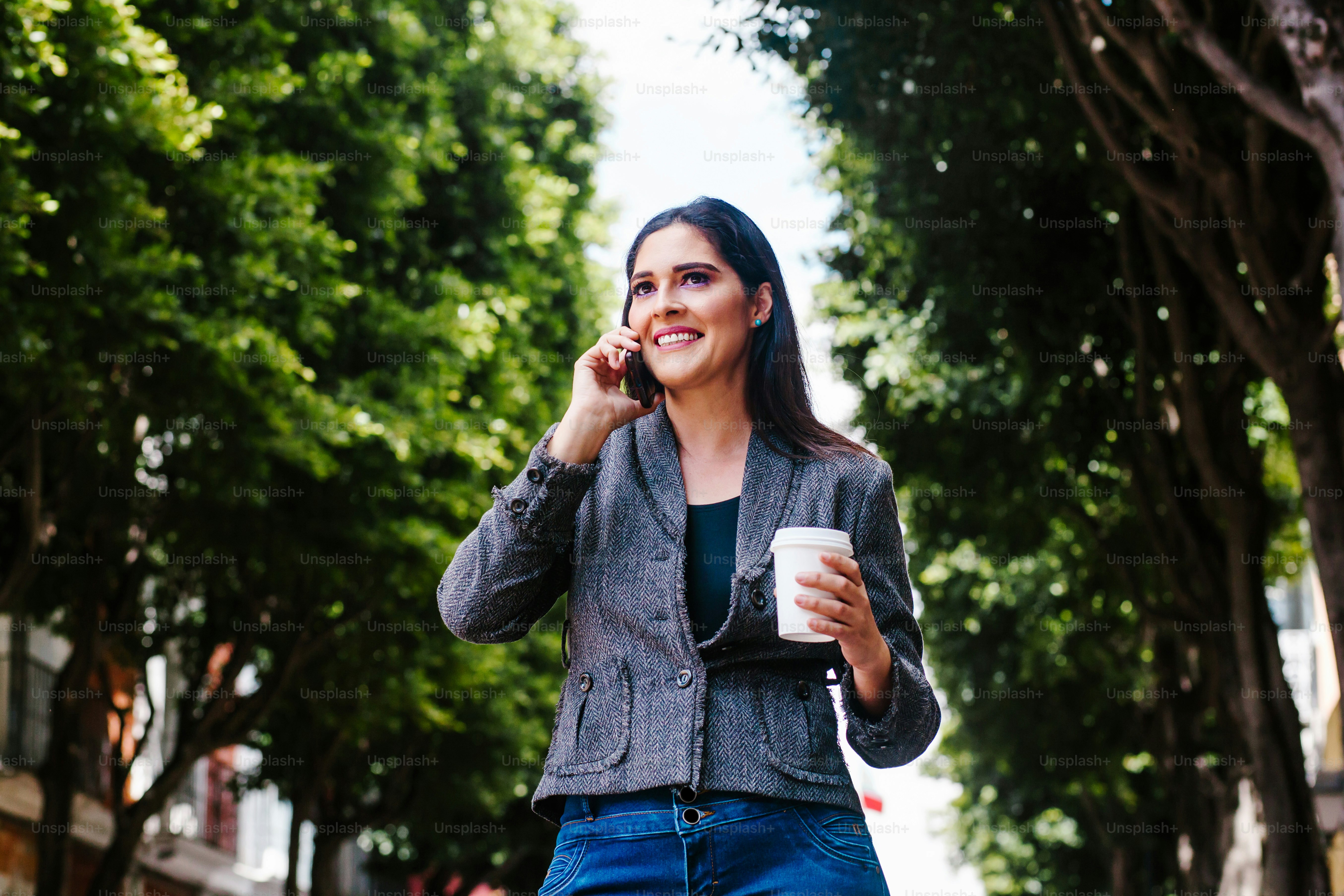 Portrait of latin business woman walking in the street of a colonial city in latin america