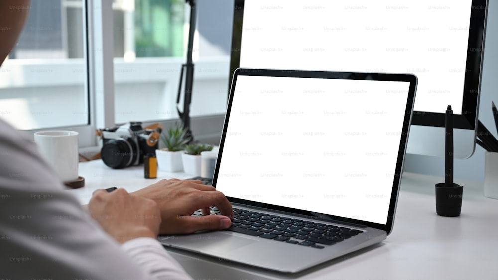 Close up view of photographer or graphic designer working with multiple device. Blank screen for graphics display montage.