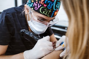 latin woman tattoo master showing a process of creation tattoo in Mexico city