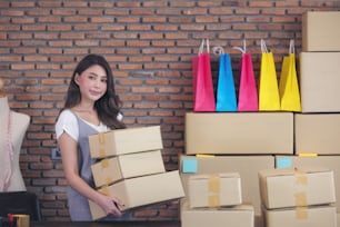 Asian freelance woman seller prepare product for packaging process at home. Online selling