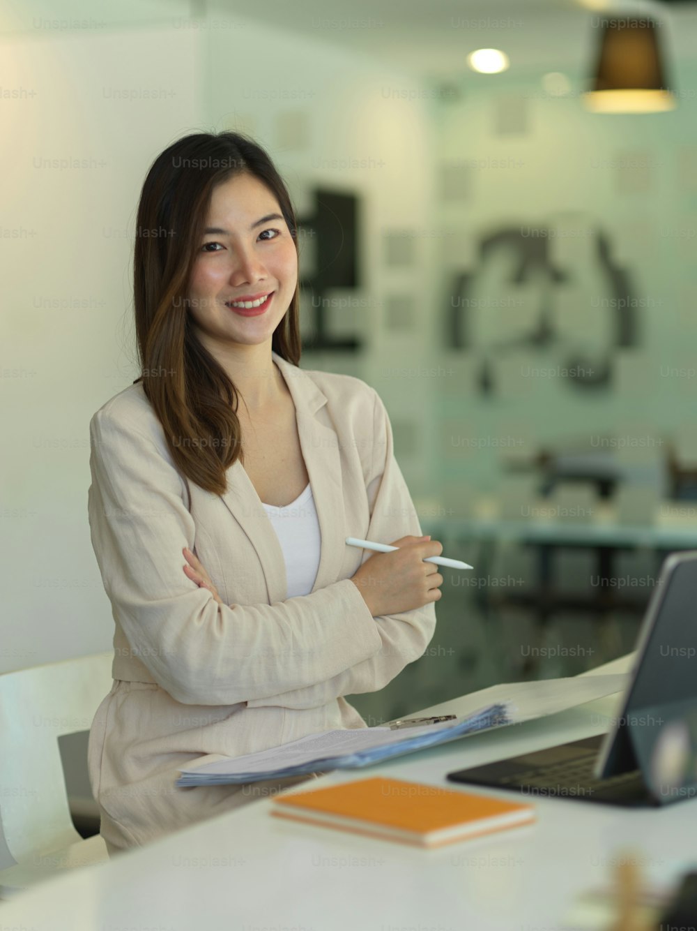 Portrait of businesswoman smiling to camera while working in office room