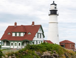 Rear view of a close up of the Portland Head Light on a cloudy summer day.