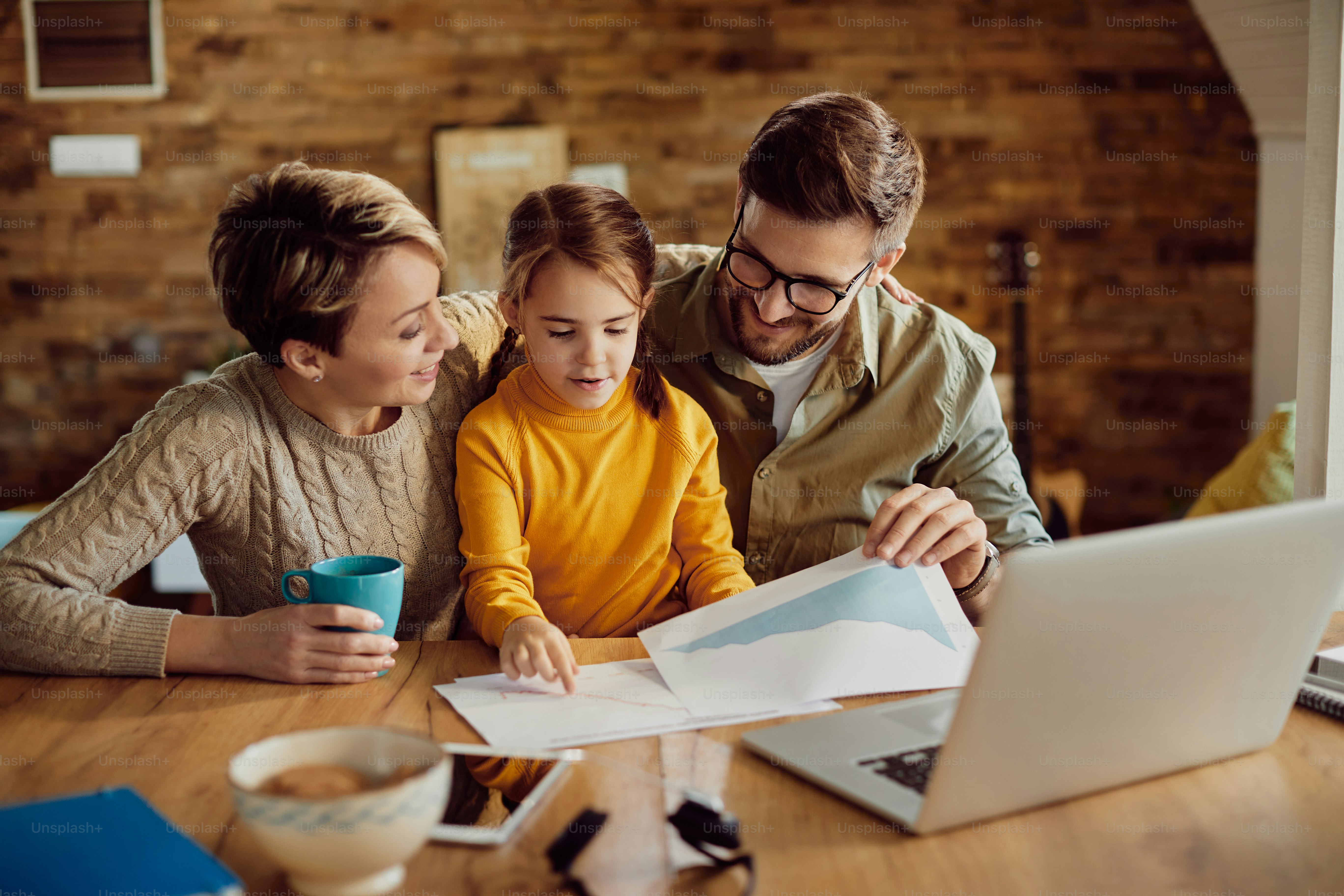 Happy family having fun while going through paperwork at home.
