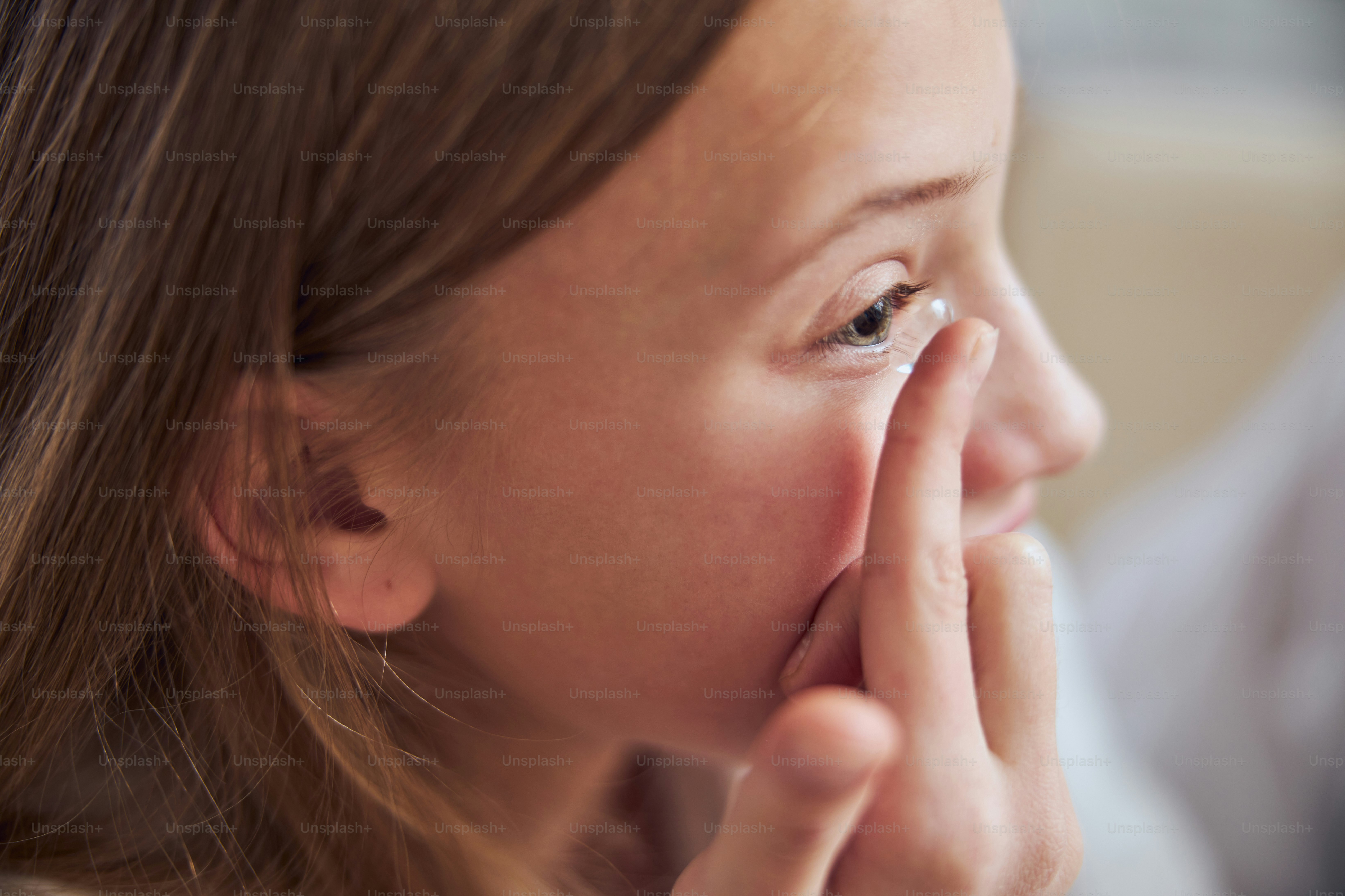 Close up side view portrait of pretty female child wearing lens on eye in room indoors