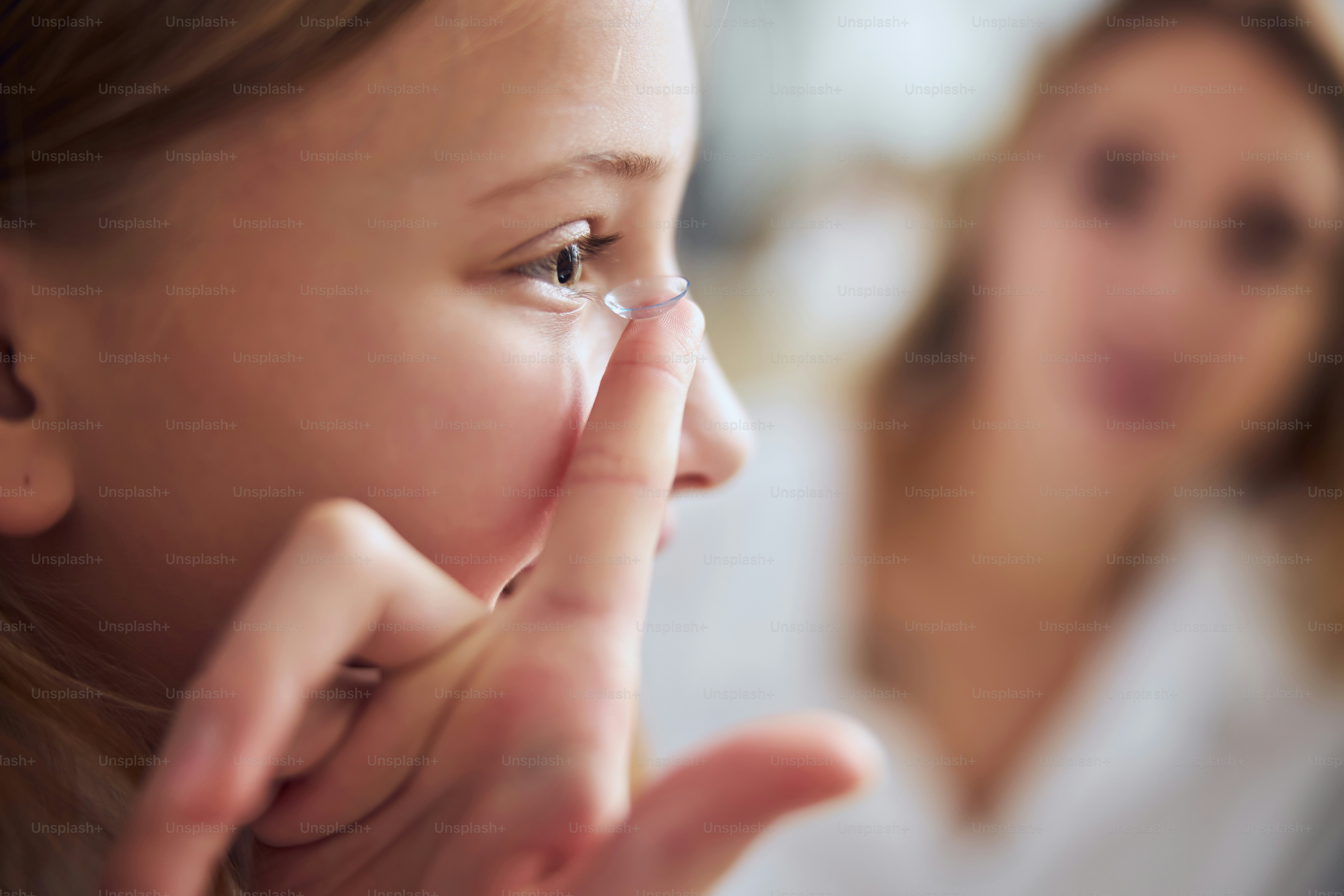 Cropped head portrait of female child choosing and trying ey