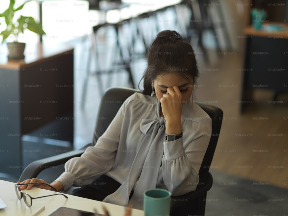 Portrait of businesswoman feeling upset while working in office room