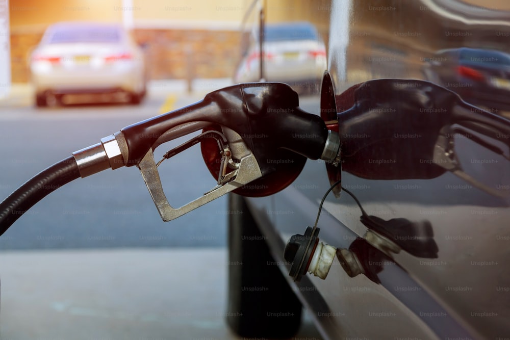 Car refueling fuel on petrol station pumping gasoline oil service is filling gas into the tank