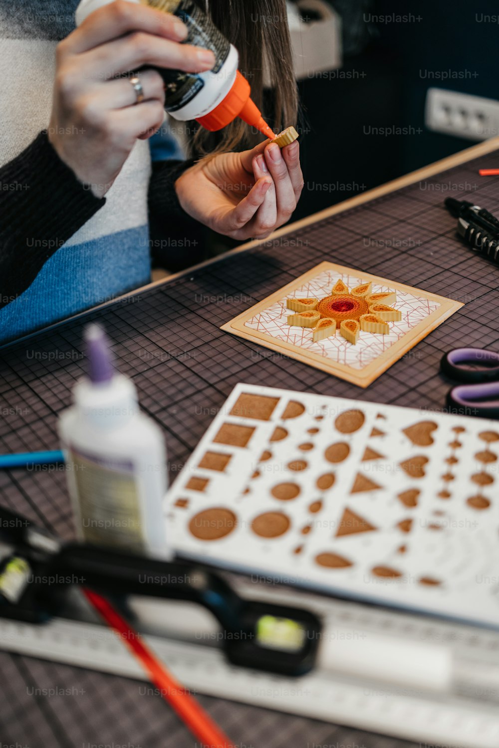 Paper art designer and artist working in her studio or workshop. Close up shot.