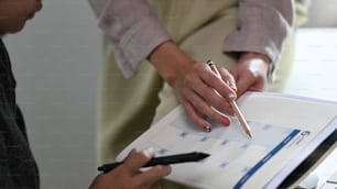 Cropped shot of business people holding calendar to schedule appointments. Calendar Planner Organization Management Concept.