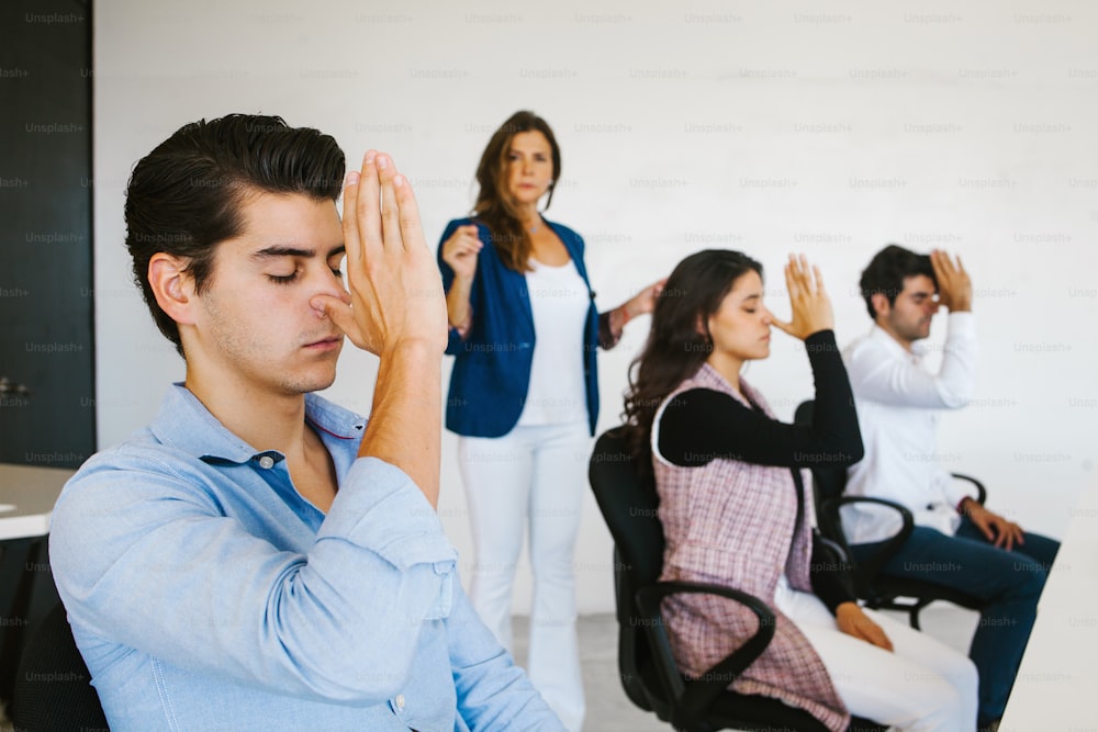 latin business people meditating and doing yoga in office in Mexico city