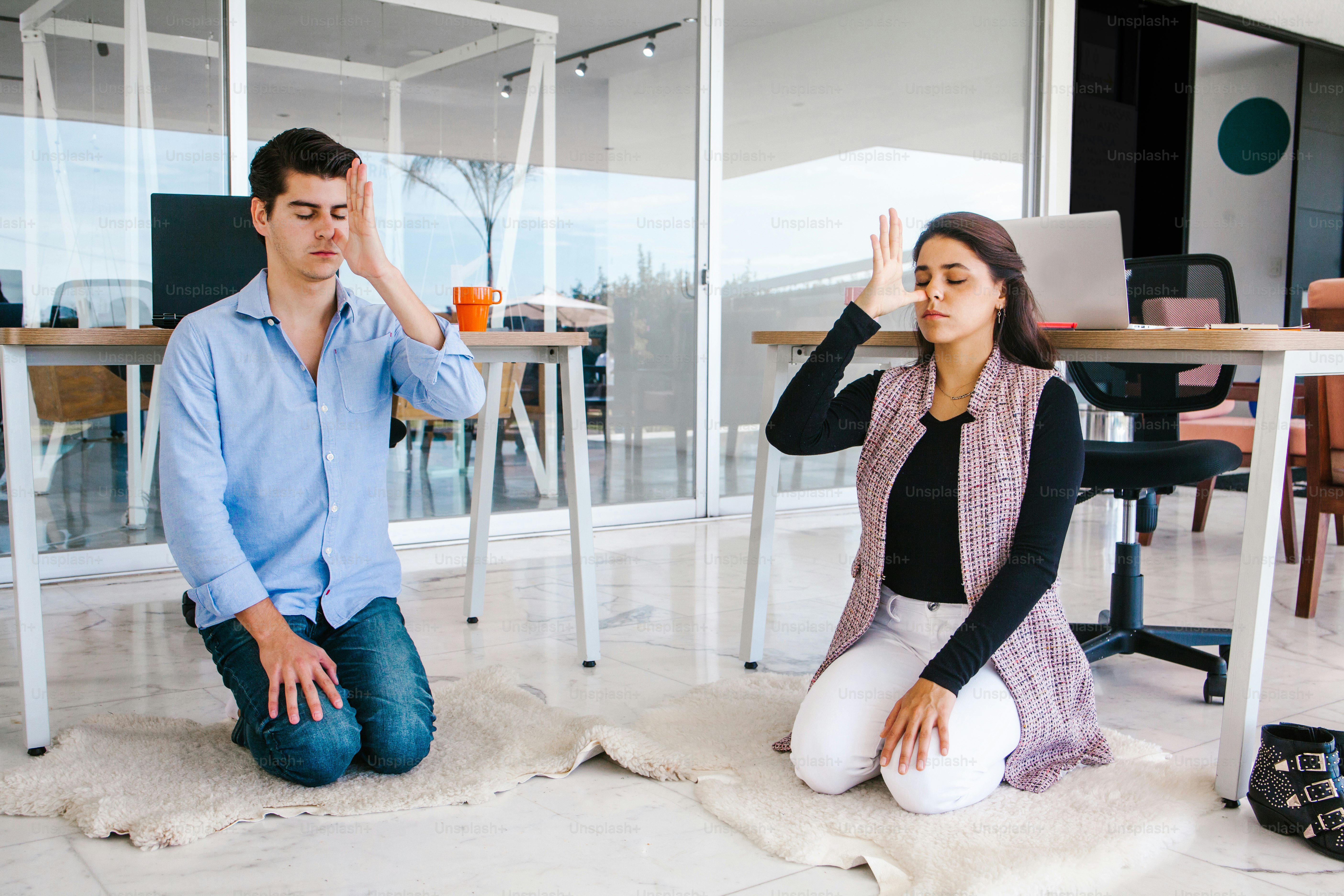 latin business people meditating and doing yoga in office in Mexico city