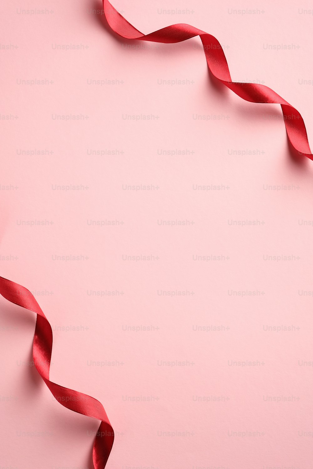 Valentines Day, Birthday, Mother Day vertical banner template with red ribbon on pink background. Minimalist style. Flat lay, top view.