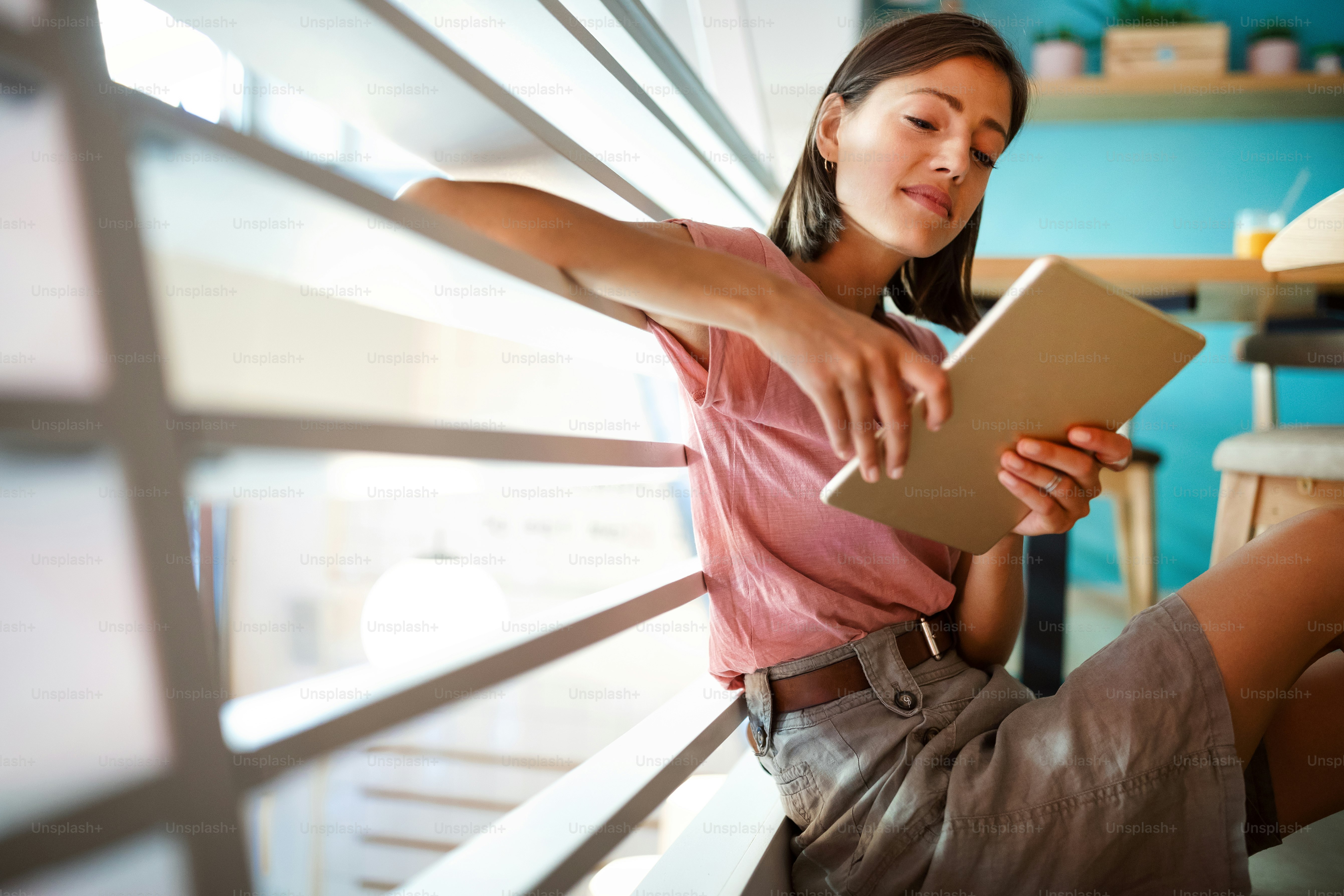 Portrait of beautiful student or businesswoman in smart casual using digital tablet