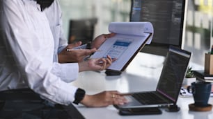 Cropped shot of programmer development team working with computer coding.