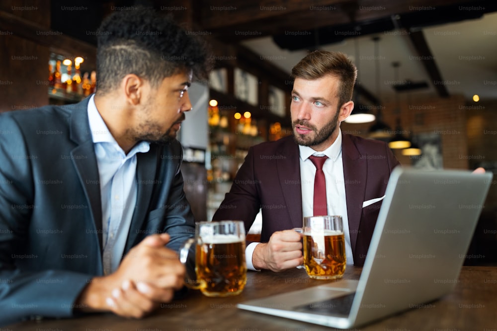 Business men talking and working together in a restaurant