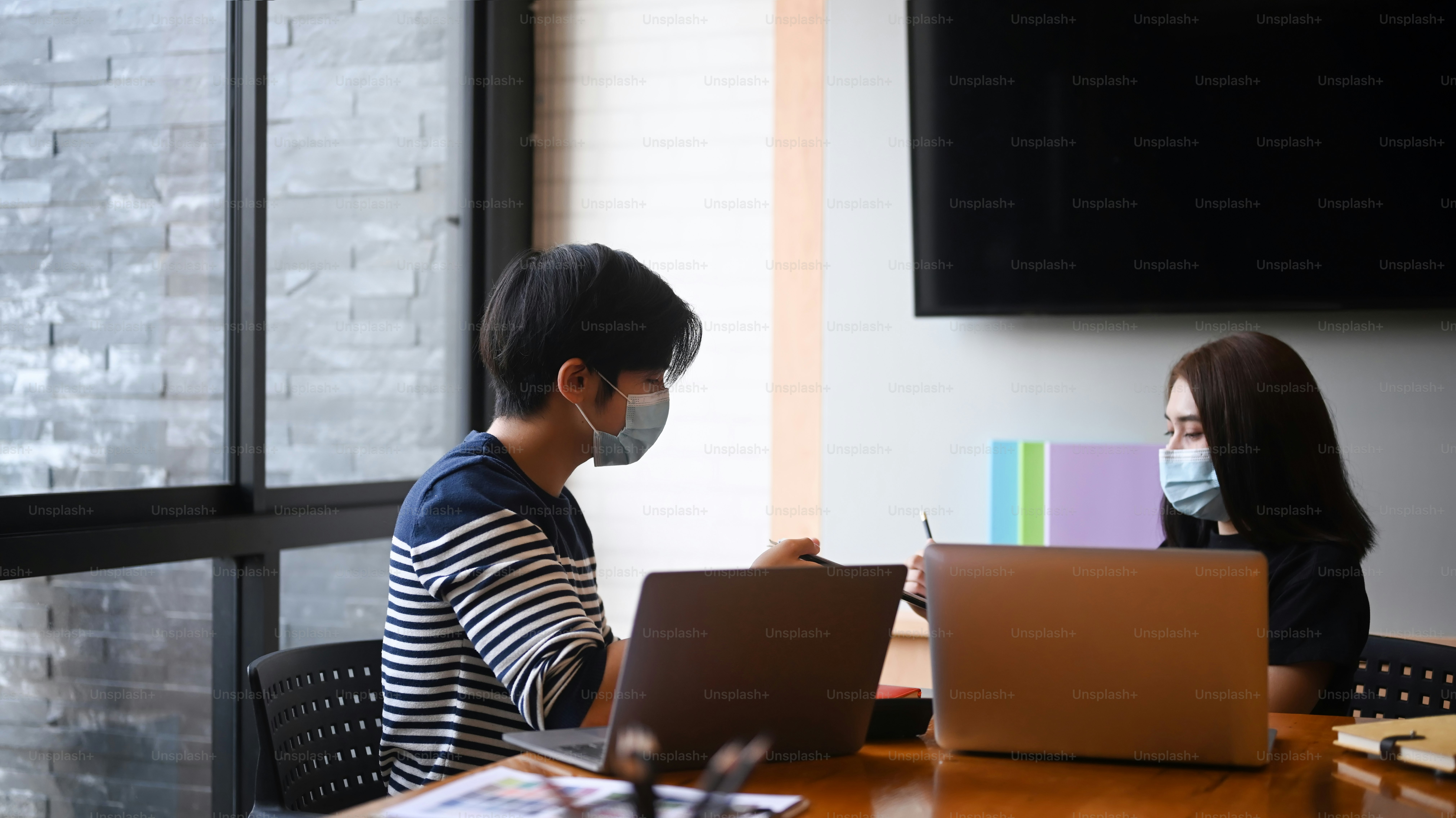 Group of creative startup people with protective mask discussing ...