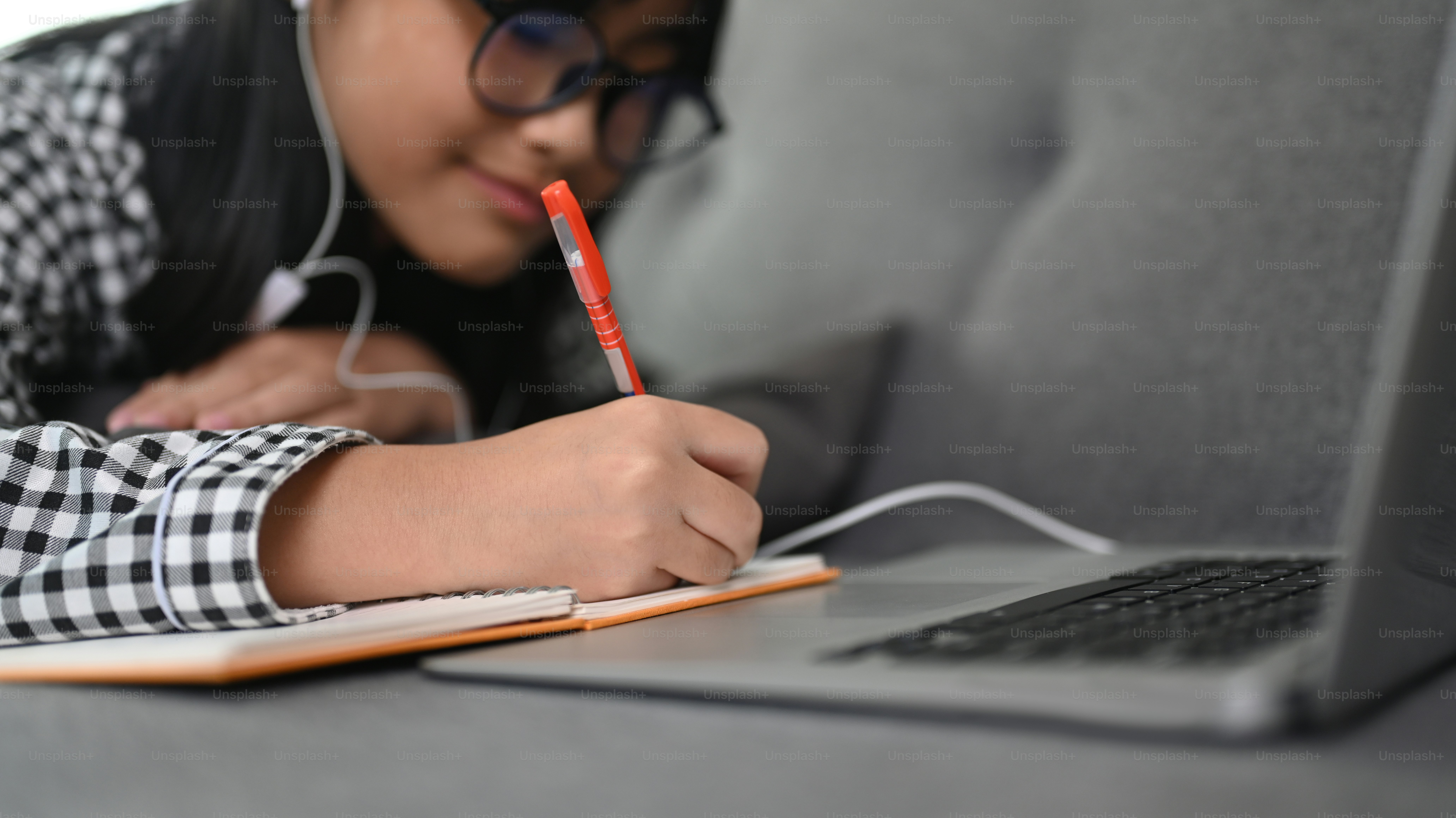 Cheerful Asian girl student using laptop computer for studying online ...