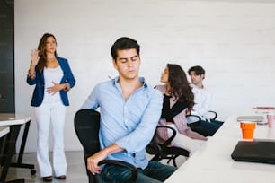 latin business people meditating and doing yoga in office in Mexico city