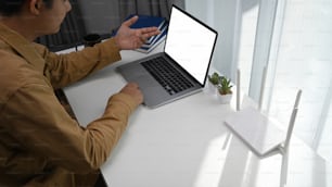 Young man using laptop having video conference with his colleague on laptop computer.