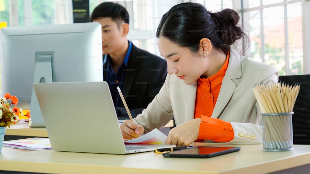 Business people working at table in modern office room while analyzing financial data report .