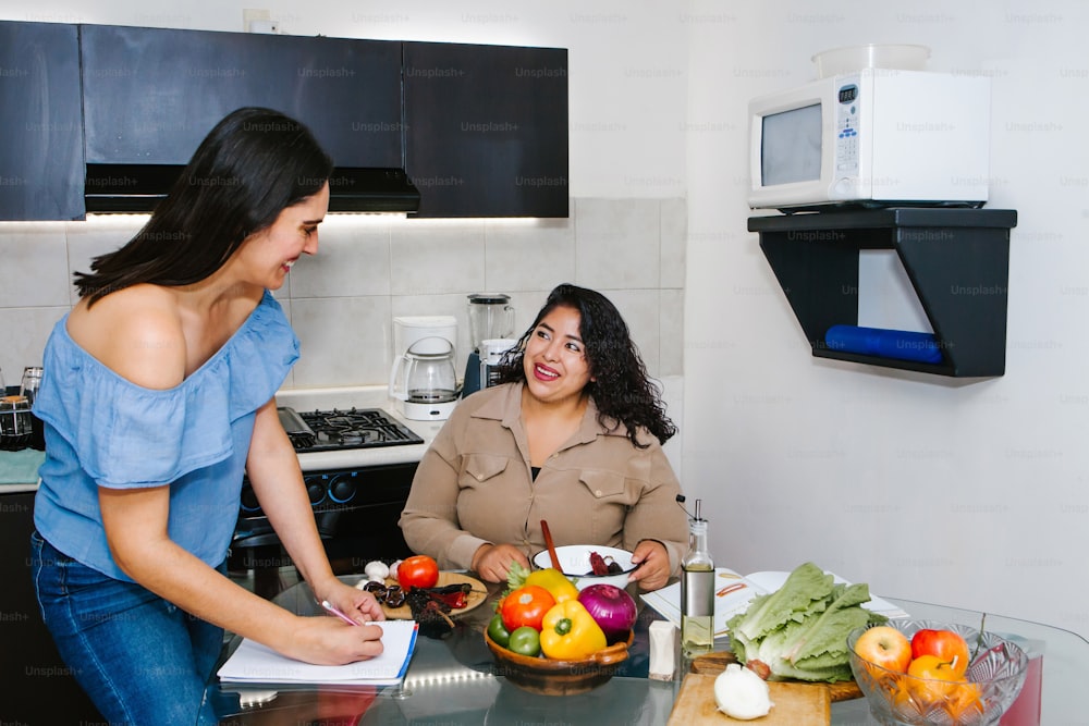 latin women cooking vegetables food and having fun in a mexican kitchen in Mexico city