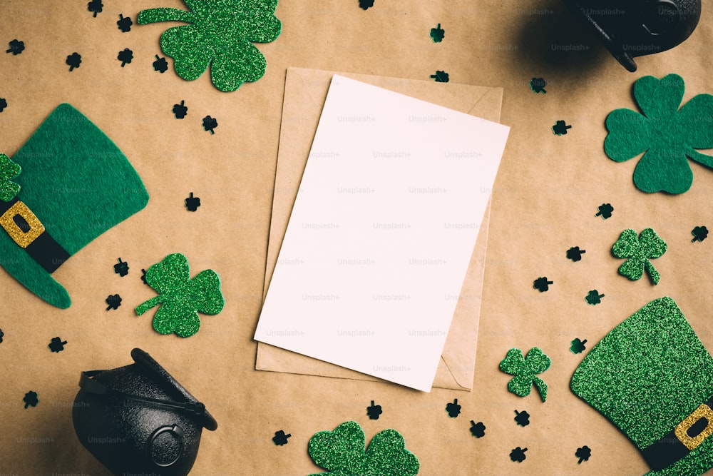 St Patrick's Day banner design. Blank paper card, Irish elf hats, pots of gold, shamrock clover leaves on kraft paper background. Happy Saint Patrickâs Day concept. Vintage, retro style.