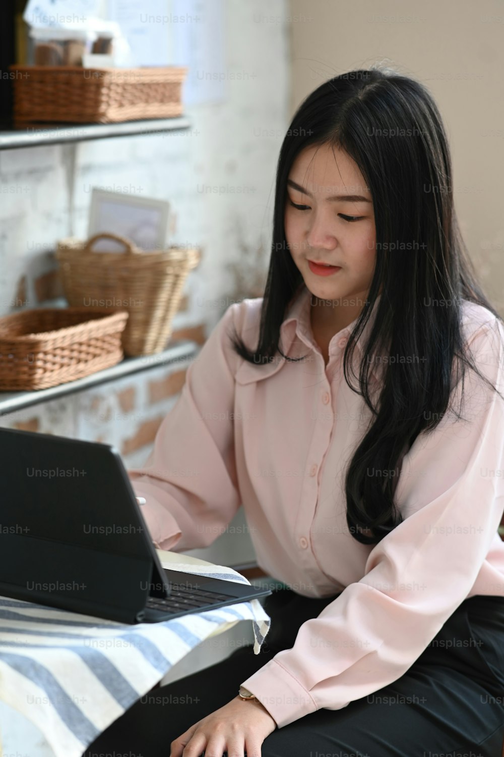 Portrait of young businesswoman working with tablet computer at cafe.