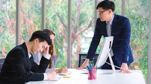 Angry business person dispute work problem in group meeting at office . Business bankrupt failure and loss concept .